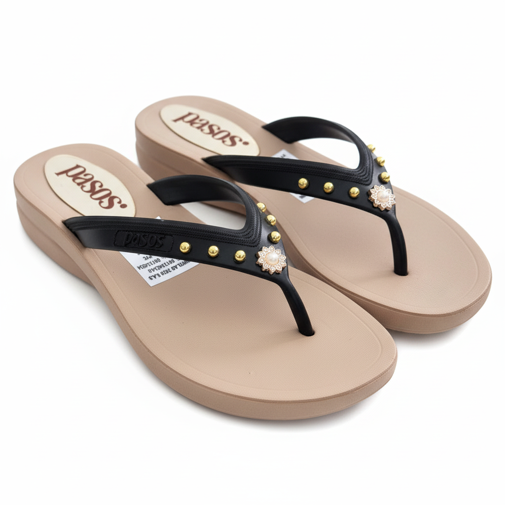 Vista angular frontal flip-flop negro con tachuelas doradas
